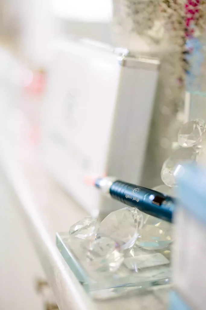 Close-up of hyaluronic acid and peptide serum dropper used after microneedling and nano-infusion treatments for hydration and repair.